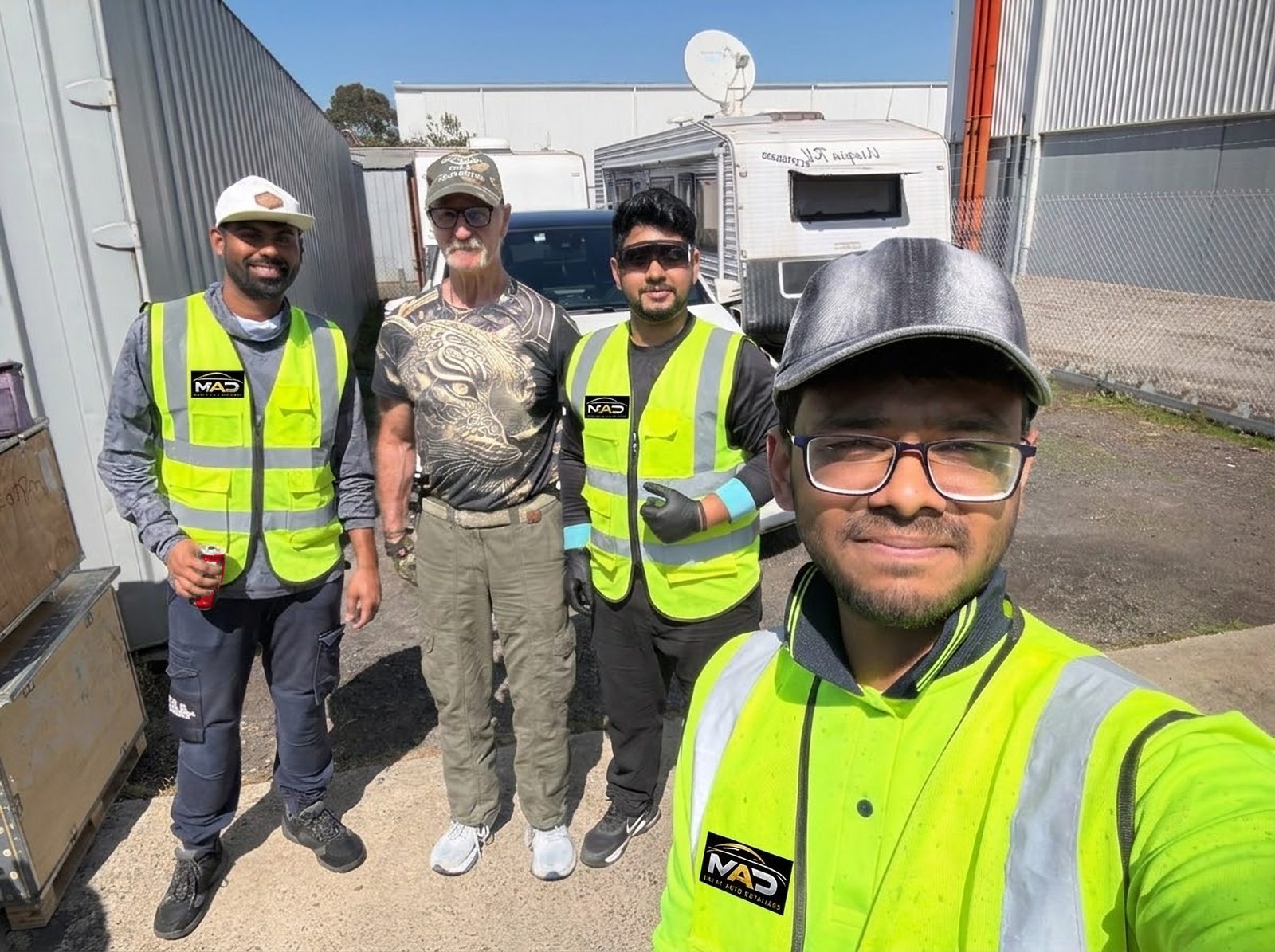 The MAD Detailers team in their hi-vis MAD vests with a happy customer and his caravan